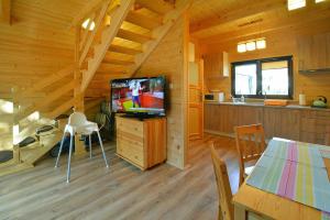 a living room with a television in a cabin at Terraced Houses, Grzybowo in Grzybowo