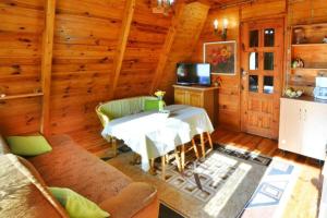 a living room with a table and a television in a cabin at Holiday home in Osieki near a lake in Osieki