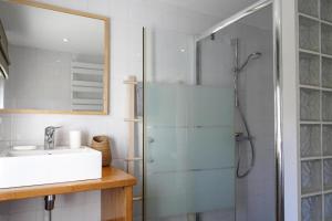 a bathroom with a shower and a sink and a mirror at Holiday Home in Brittany near Sandy Beaches in Locquirec +18 photos