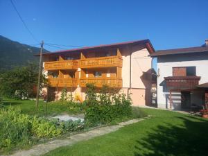 a building with a balcony on the side of it at Apartments Masera in Kobarid