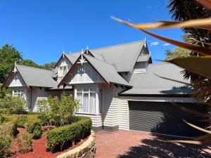 a house with a gray roof and a yard at Serenity in Healesville