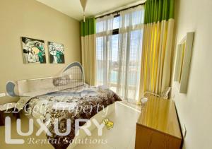 a bedroom with a bed and a large window at Tawila Villa T1-15 in Hurghada