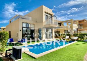 a villa with a swimming pool in front of it at Tawila Villa T1-15 in Hurghada