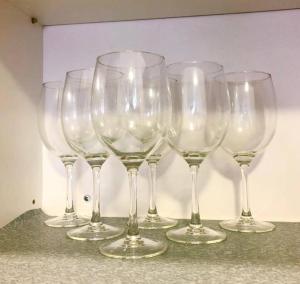 a group of wine glasses sitting on a counter at Cozy Mayfair Homestay in Puchong