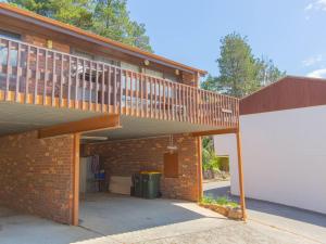 a brick building with a balcony and a garage at Snowy Saga 1 46 Gippsland Street in Jindabyne