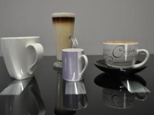 two coffee cups sitting on top of a table at Canford Crossing in Wimborne Minster