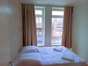 Postel nebo postele na pokoji v ubytování Puschkin Rooms