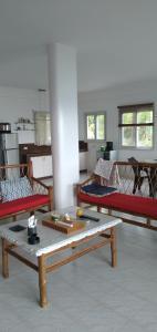 a room with three beds and a table in it at SPANISH VILLA Lonos ROMBLON in Agnay