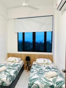 Postel nebo postele na pokoji v ubytování Imperio Homestay Alor Star + 37 fotografií