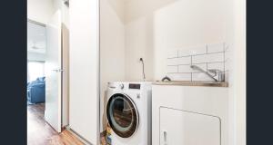 a white laundry room with a washing machine at Old Port Townhouse Central to Everything in Echuca
