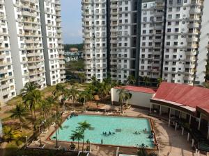 an overhead view of a swimming pool with tall buildings at AF Family Guesthouse in Port Dickson