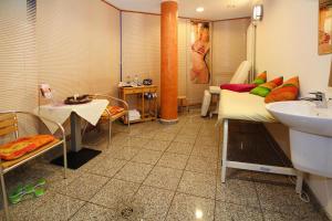 a bathroom with a bed and a sink in it at Ferienhäuser im Tannenpark, Tanne in Tanne