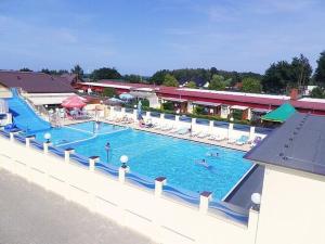 a large swimming pool with people swimming in it at Holiday resort, Sianozety in Sianozety