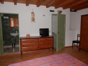 a room with a dresser and a bathroom with a sink at Calì B&B in Alatri