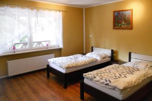 2 Betten in einem Zimmer mit Fenster in der Unterkunft Holiday flat, Stepnica in Stepnica