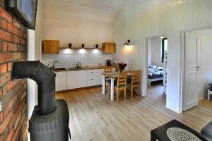 a kitchen and living room with a wood stove at Family holiday homes, Jaroslawiec in Jarosławiec