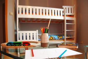 a childs desk with a toy train on a bunk bed at Holiday flat im Wasserturm Güstrow - DMS01100b-P in Güstrow