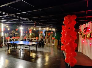 a room with a table with red balloons in it at Kuruva Island Resort And Spa - By KABINI BREEZE, Wayanad in Mananthavady +37 photos