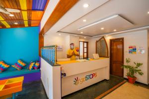 a man standing at a counter in a room at goSTOPS Bengaluru, Gandhi Nagar Majestic in Bangalore