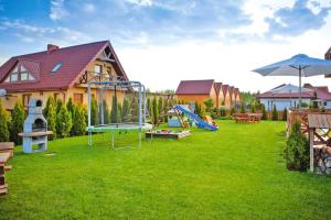 a yard with a playground in front of a house at Semi-detached houses, Rowy in Rowy