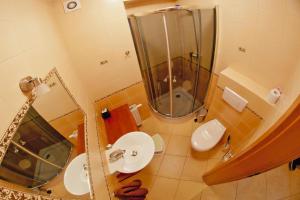a bathroom with a sink and a shower and a toilet at Semi-detached houses, Rowy in Rowy