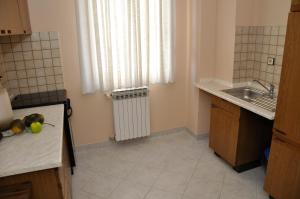 a small kitchen with a sink and a window at Apartments Crobeg in Rab +44 photos