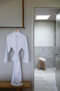 a white robe hanging on a wall in a room at Cassis Red Hill in Red Hill +60 photos