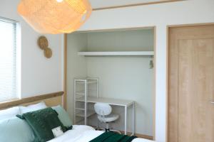 a bedroom with a bed and a desk at SHIOYA STAY in Okinawa City +41 photos