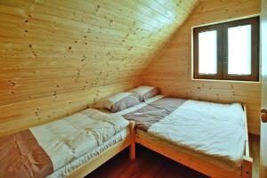 a room with two beds in a log cabin at Holiday resort, Sarbinowo in Sarbinowo