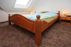 a wooden bed in a bedroom with a window at Apartments, Mirow in Mirow