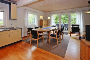 a kitchen and dining room with a table and chairs at Holiday resort in the Müritz National Park, Mirow in Mirow