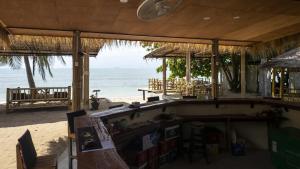 a beach bar with a view of the ocean at Isara Lanta Beach Resort in Ko Lanta