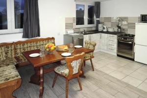 a kitchen and dining room with a wooden table and chairs at Holiday flat, Kolczewo in Kołczewo