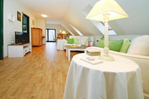 a living room with a table with a lamp on it at Holiday home Seeadler am Dümmer See in Dümmer in Dümmer