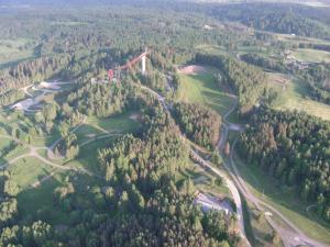 an aerial view of a forest with a bridge at Tehvandi Hotell in Otepää
