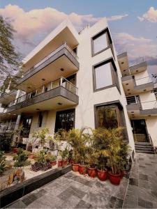 a building with potted plants in front of it at Yuhi Suites in Gurgaon