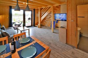 a log cabin with a living room and a tv at Terraced Houses, Sianozety in Sianozety