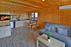 a kitchen and living room with a couch and a table at Terraced Houses, Sianozety in Sianozety