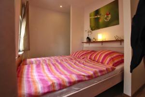 a bedroom with a bed with a striped comforter at Apartment at the Goethe Park, Leipzig in Leipzig