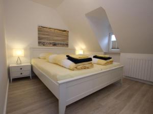 a white bed with two pillows on it in a room at Ferienwohnung in St Peter-Ording in Sankt Peter-Ording +34 photos