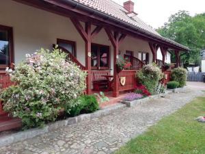 a house with flowers in the front yard at Holiday homes under the willow tree, Kolczewo in Kołczewo