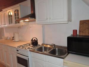 a kitchen with a sink and a stove top oven at Holiday home in Stepnica in Stepnica