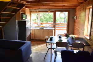 a kitchen and dining room with a table and chairs at holiday home, Parchowo in Parchowo