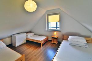 a small room with two beds and a window at Holiday bungalow for 4 people Jaroslawiec in Jarosławiec
