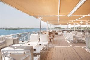 a deck on a boat with tables and chairs at Jaz Regent Nile Cruise - Every Monday from Luxor for 07 & 04 Nights - Every Friday From Aswan for 03 Nights in Luxor