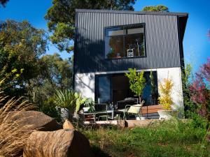 a small house with a black roof at Retreat 34A in Daylesford