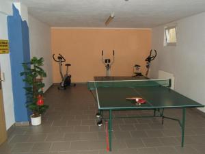 a ping pong table in a room with exercise equipment at Gästehaus Glaagut - Familie Hain in Hochfilzen