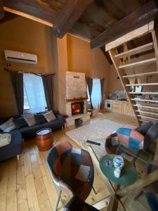 a living room with a couch and a fireplace at house s&d in Otočac