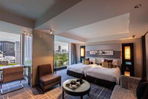 a hotel room with two beds and a large window at Hotel New Otani Tokyo EXECUTIVE HOUSE ZEN in Tokyo