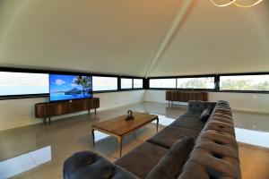 a living room with a couch and a tv at Casa Blanca in Fethiye